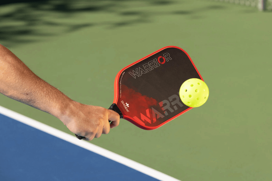 Diadem Warrior Pickleball Paddle in hand hitting ball