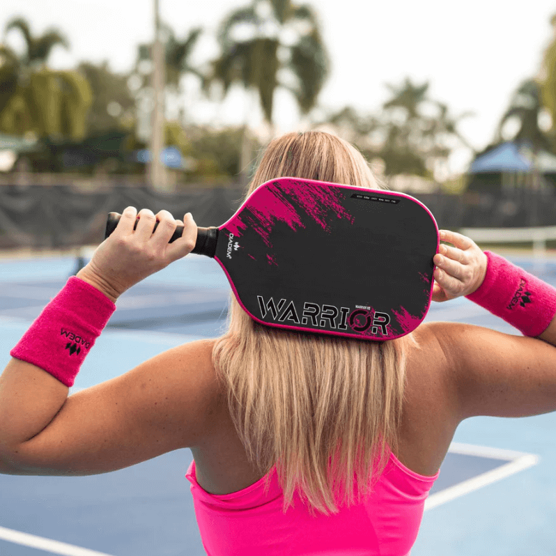 Pickleball player holding pink diadem warrior v2 behind head