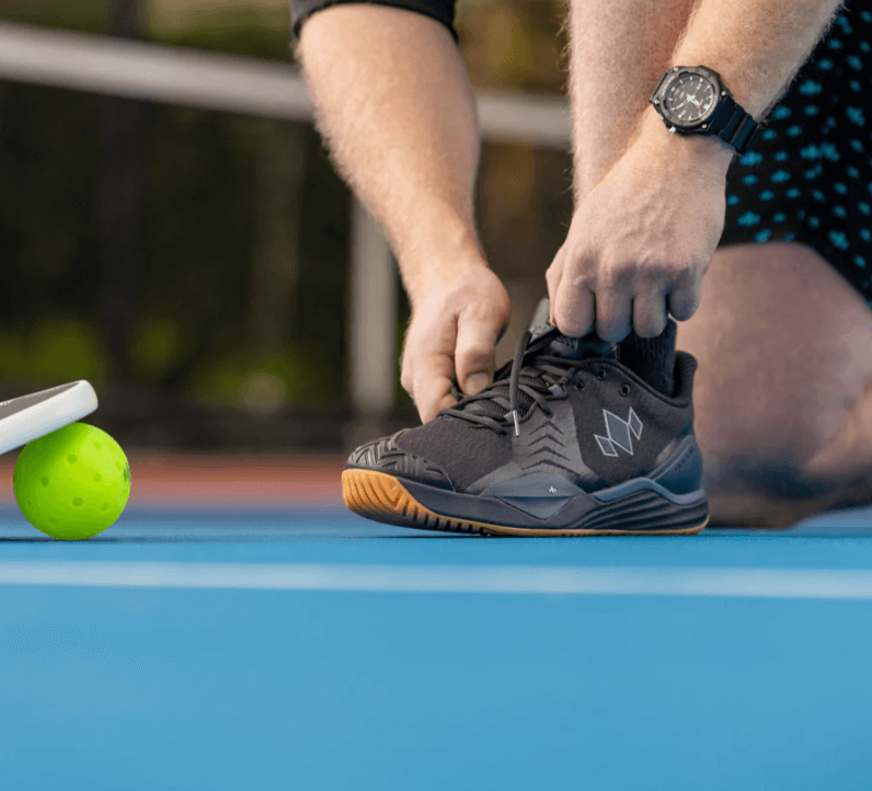 Pickleball player tying Diadem Court Burst Pickleball Shoes