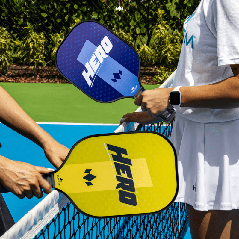 Pickleball players holding Diadem Hero paddles