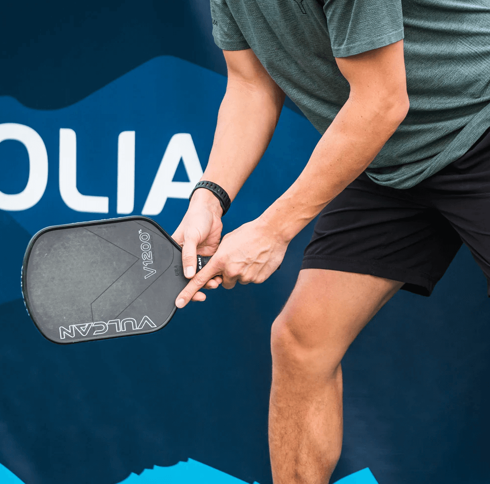 Player holding Vulcan V1200TL Pickleball Paddle